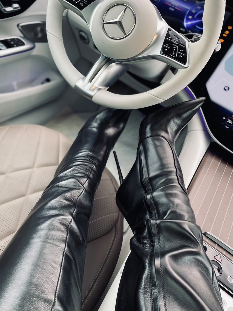 POV view of a model’s legs in a luxury car wearing 1969 Made in Italy black nappa leather LX over-the-knee pointy boots.