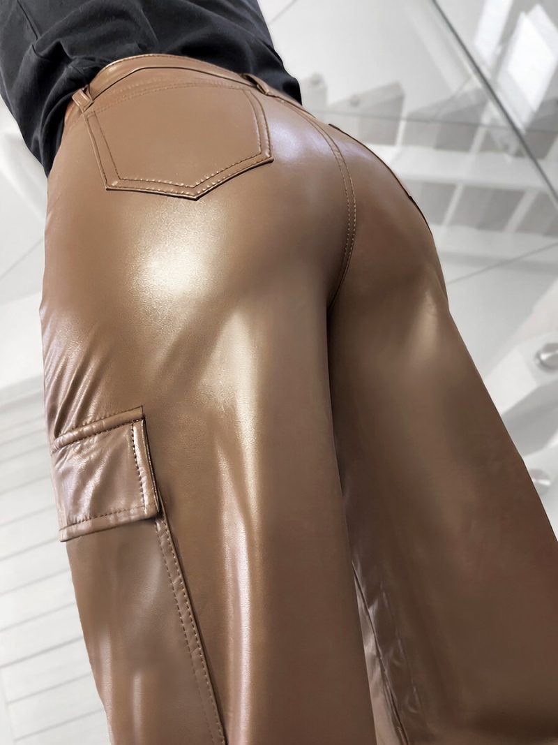 Close-up of dark beige eco-leather texture on cargo pants with pocket detail