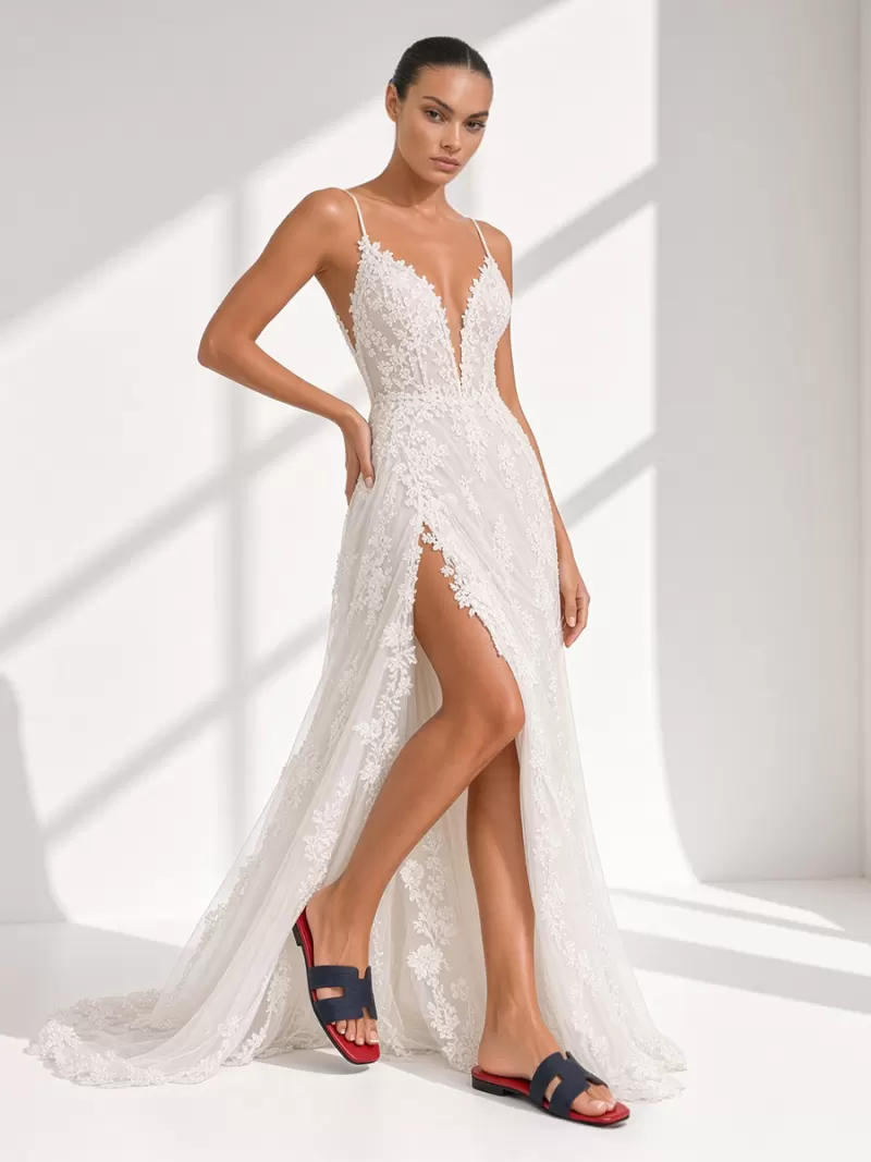 Full-length view of model in white lace dress wearing dark blue croc suede flat slide sandals with red footbed.