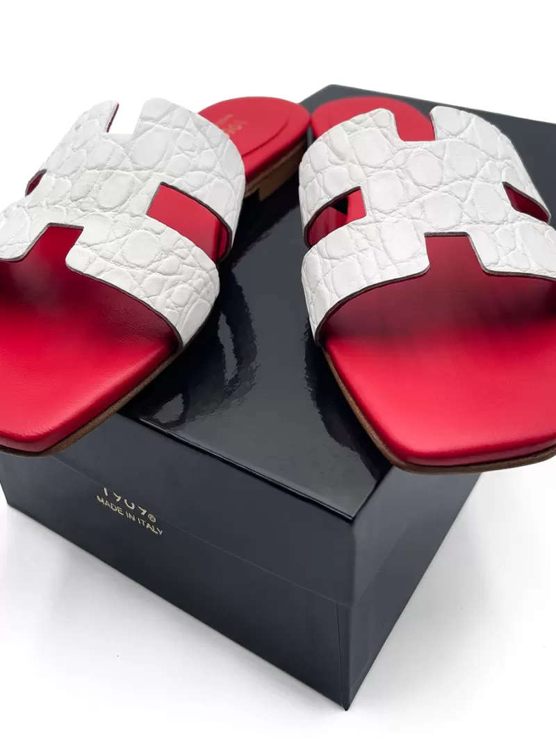 Oran white croc-embossed leather flat sandals with H-cut uppers and red footbeds displayed on a black 1969 Made in Italy shoe box.
