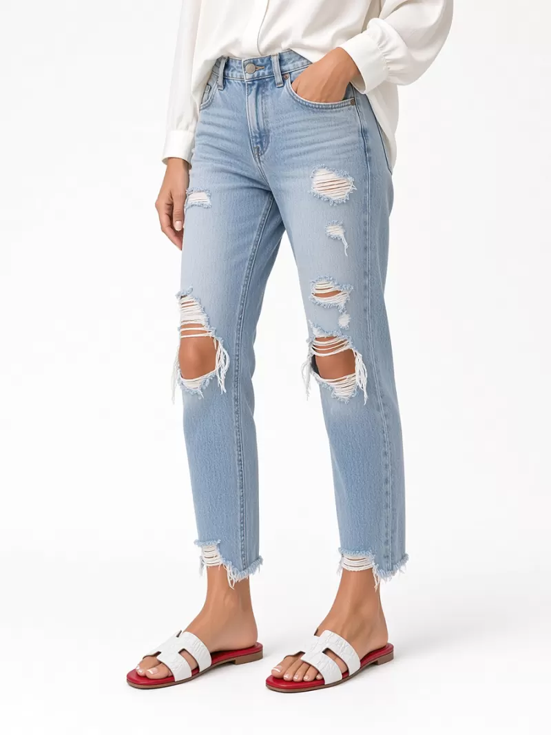 Model wearing Oran white croc-embossed leather flat sandals with red footbeds, distressed light-blue jeans and a white blouse.