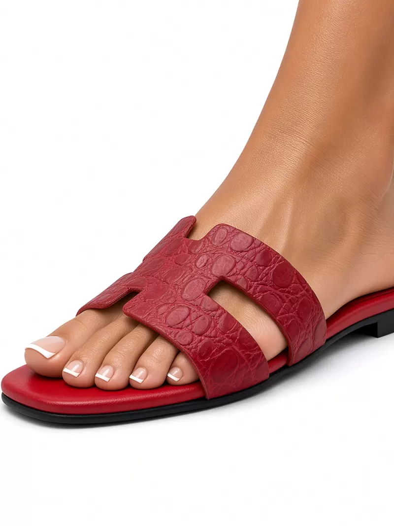 Side view of 1969 Made in Italy red croc-embossed leather flat sandal worn on foot.