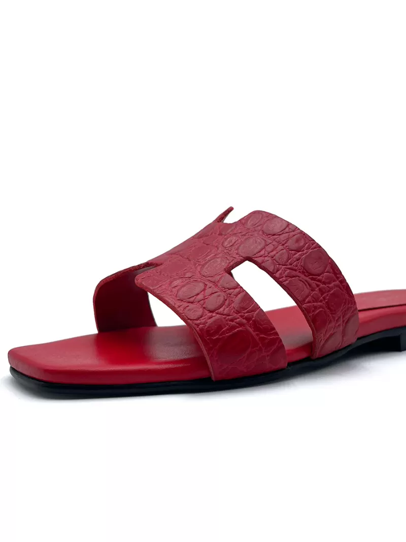 Single side view of 1969 red croc-embossed leather flat sandal showing H-strap and matching red footbed.