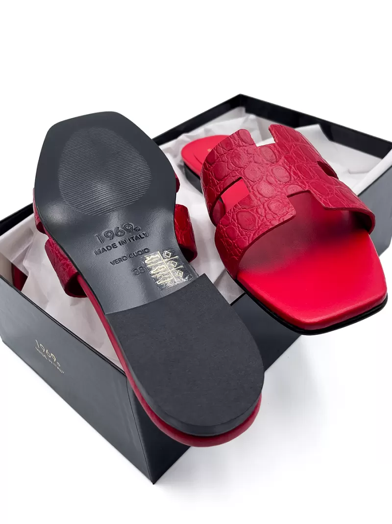 1969 red croc leather flat sandals on black shoe box showing H-strap and Vero Cuoio genuine leather sole.