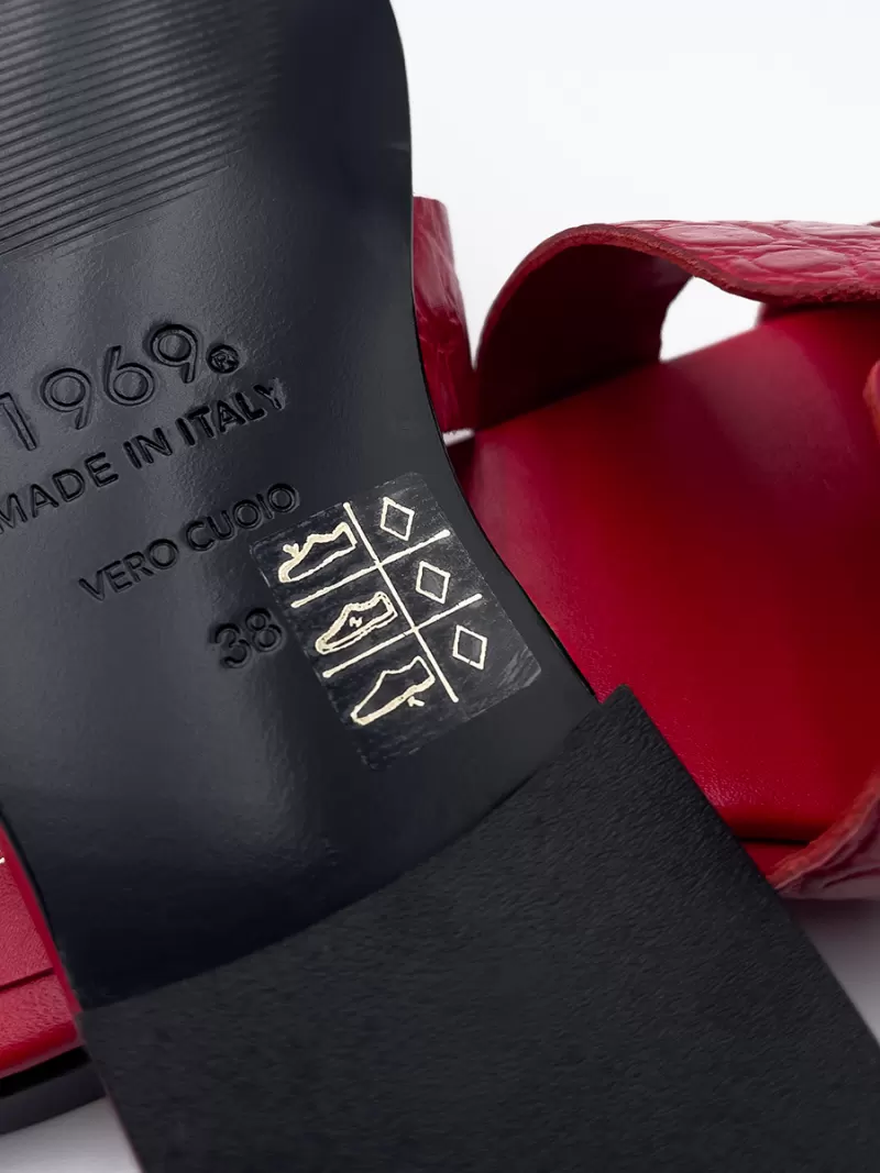 Close-up of 1969 red croc leather flat sandal sole showing Vero Cuoio genuine leather stamp.